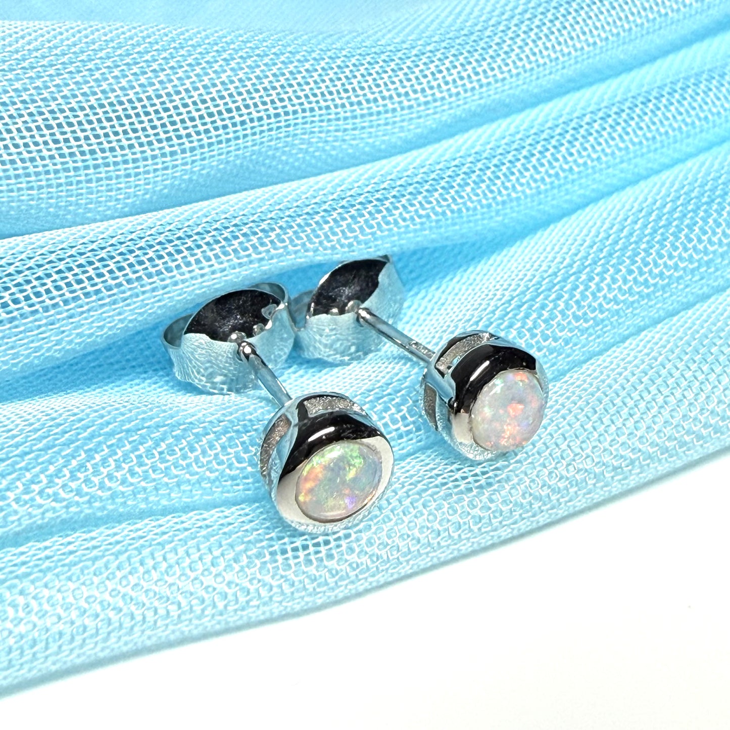 Pair of real opal earrings round white gold stud smooth rubbed over setting