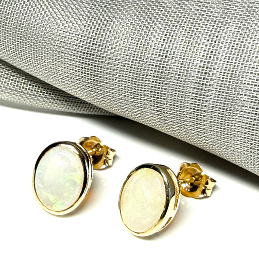 Pair of real opal yellow gold oval stud earrings
