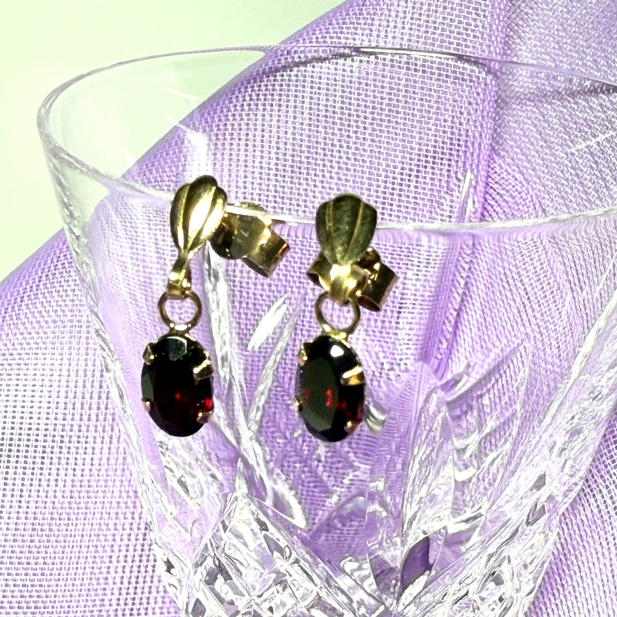 A pair of real red garnet drop earrings oval shaped yellow gold