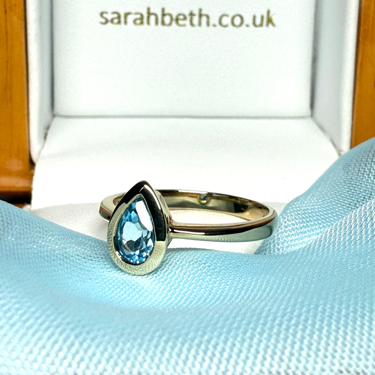 Pear shaped real blue topaz yellow gold dress ring teardrop