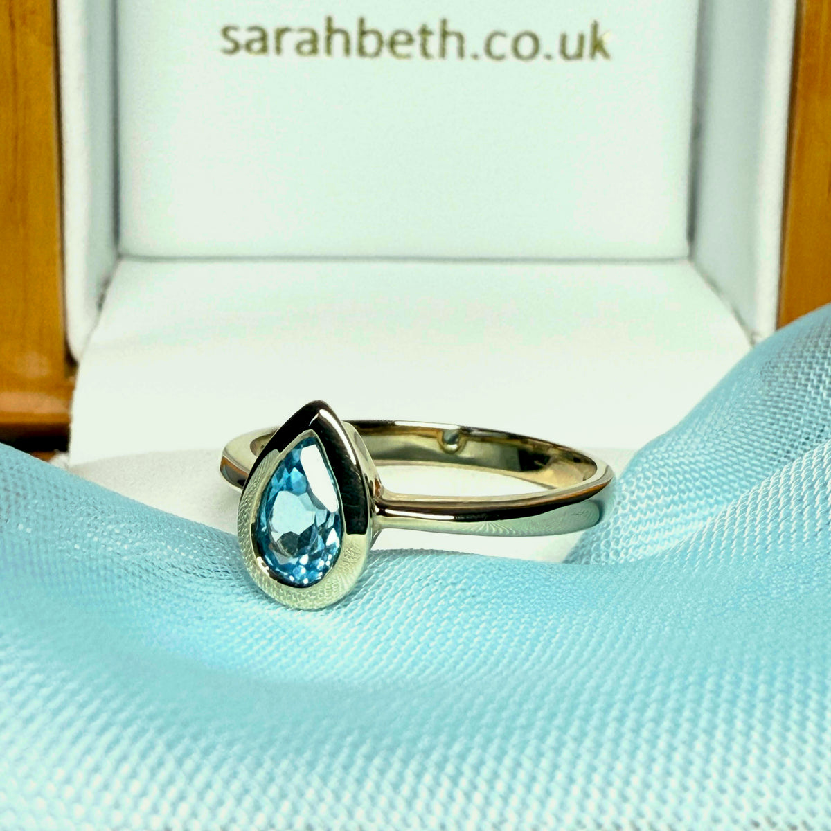 Pear shaped real blue topaz yellow gold dress ring teardrop