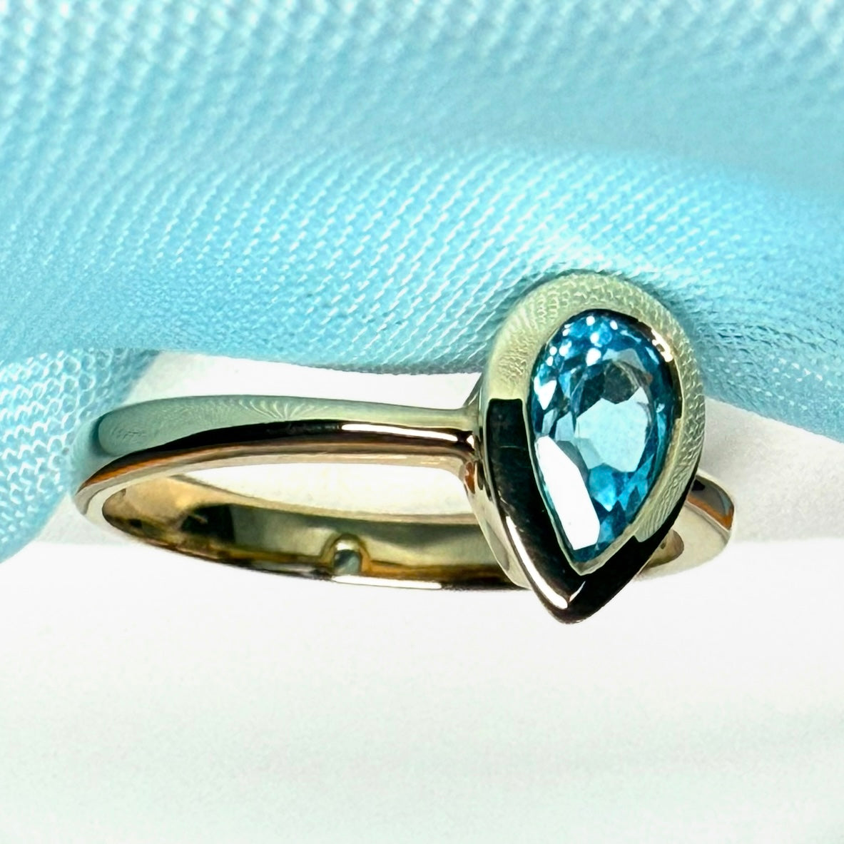Pear shaped real blue topaz yellow gold dress ring teardrop