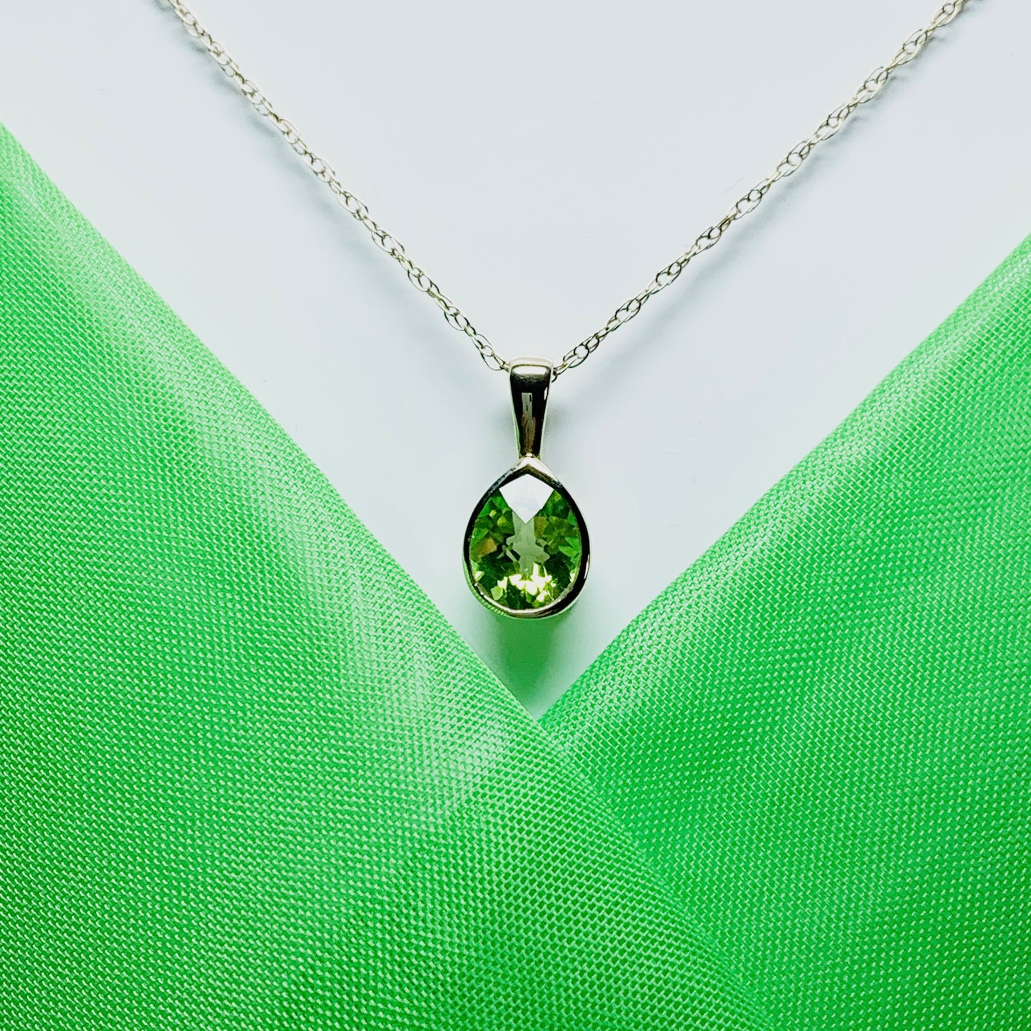 Pear peridot rubbed over yellow gold necklace