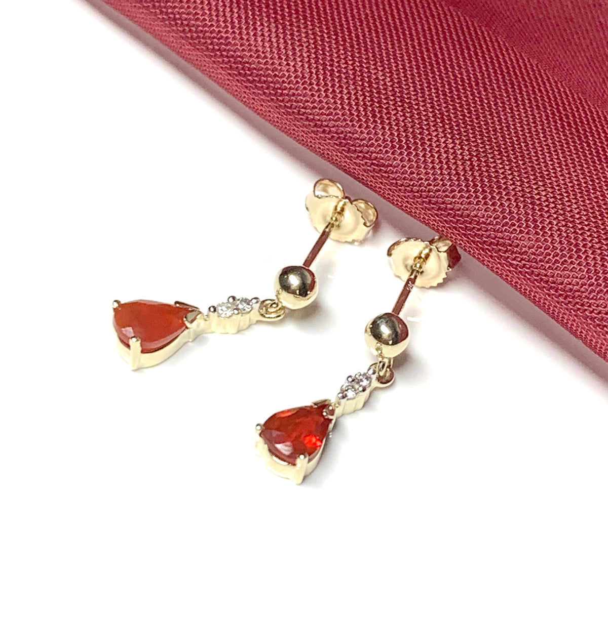 Pear shaped orange real fire opal and diamond drop earrings yellow gold