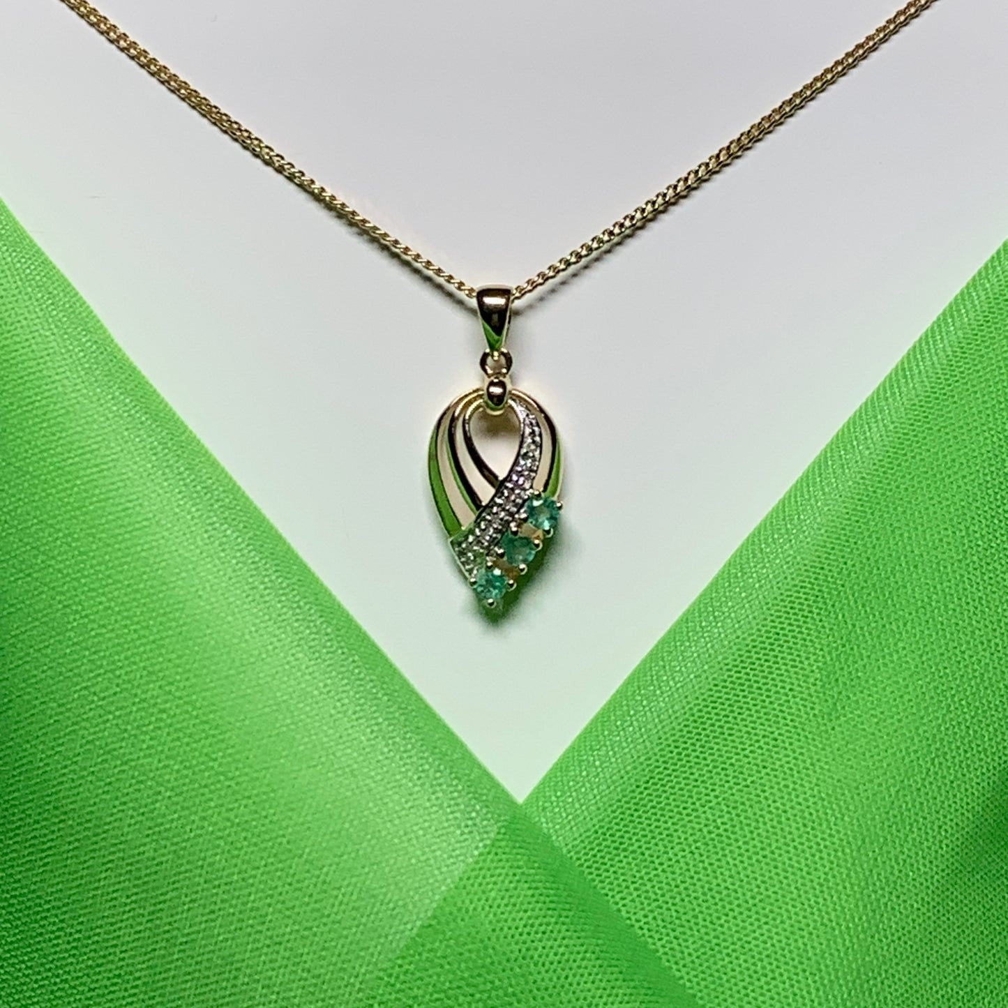 Pear shaped real green emerald and diamond spray necklace yellow gold