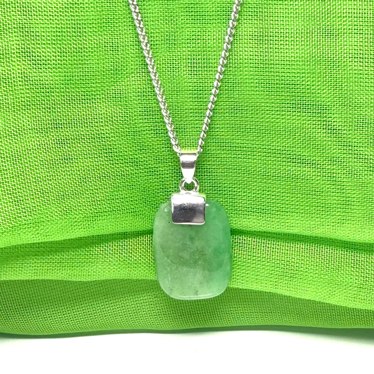 Pendant necklace having a real green jade stone sterling silver cushion shaped with a chain