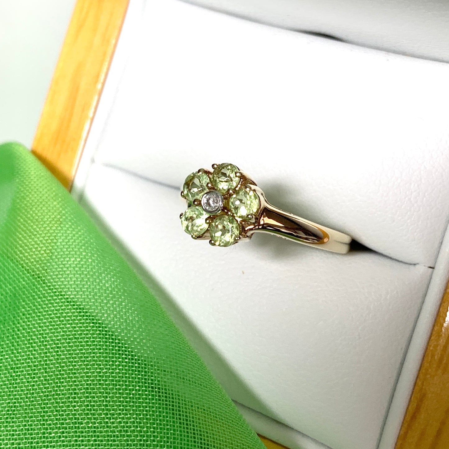 Peridot and diamond yellow gold daisy cluster ring