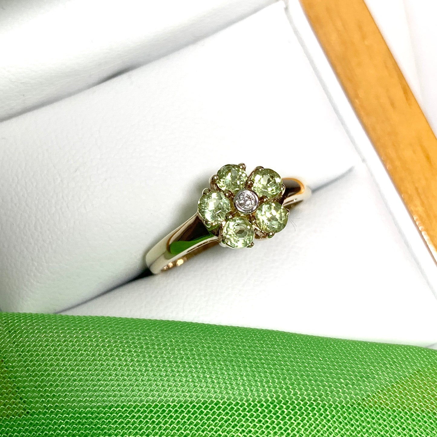 Peridot and diamond yellow gold daisy cluster ring