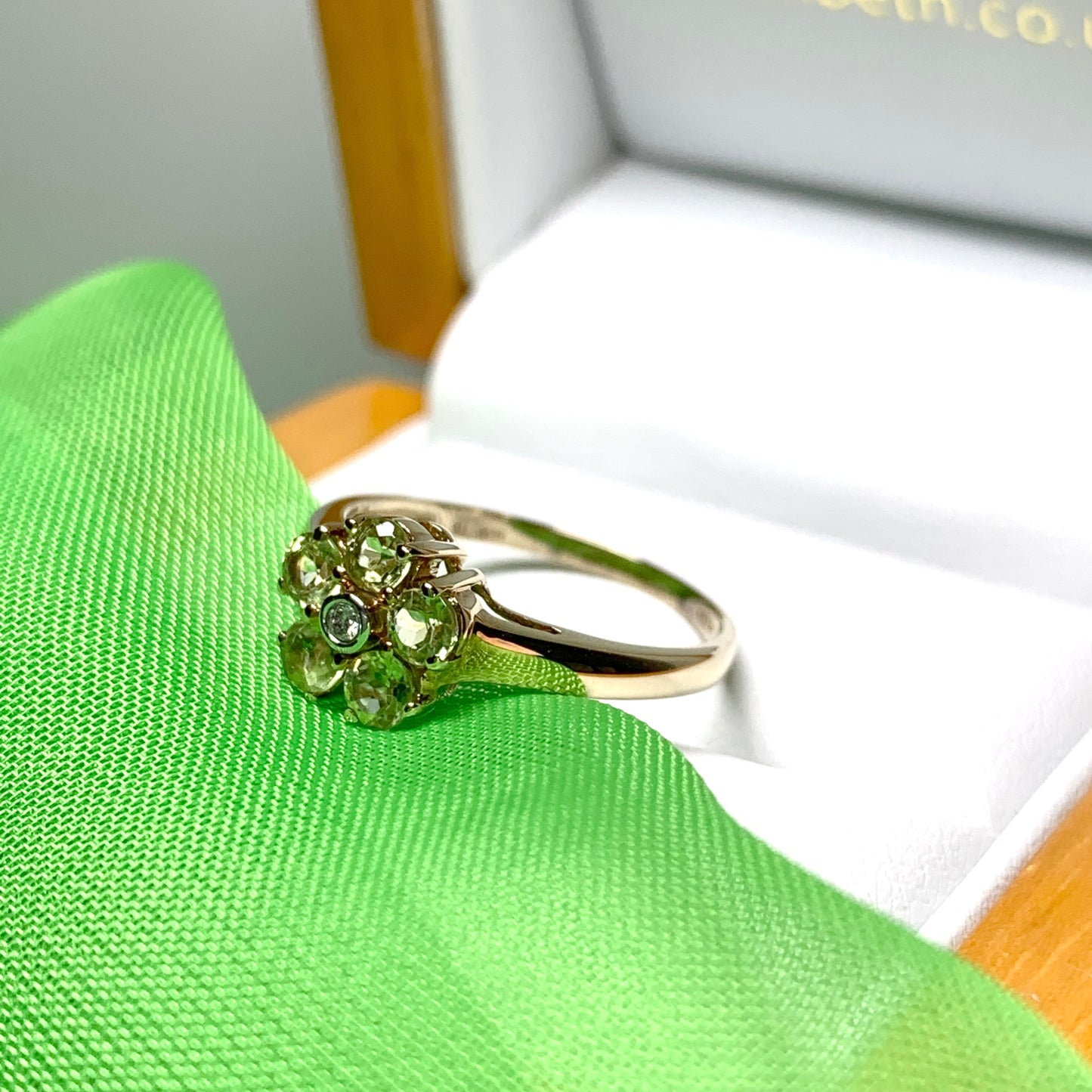 Peridot and diamond yellow gold daisy cluster ring