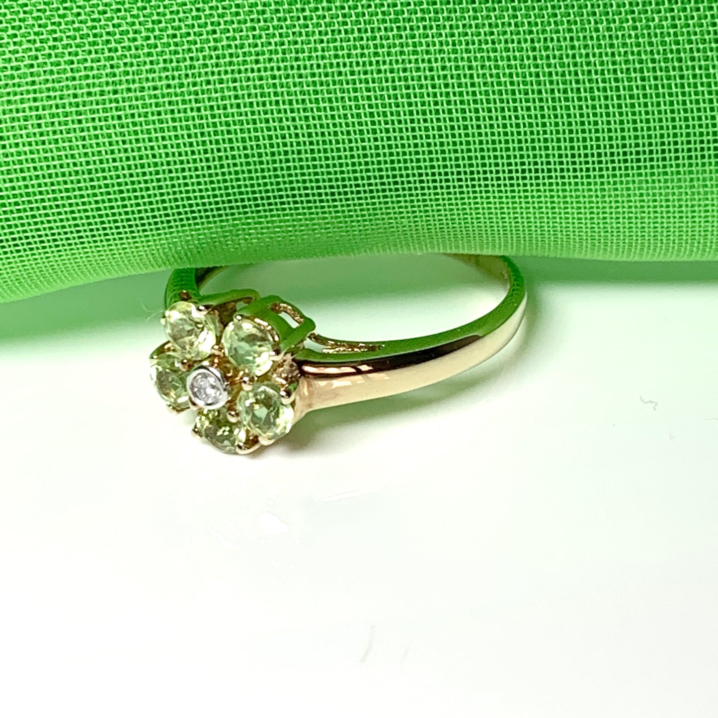 Peridot and diamond yellow gold daisy cluster ring