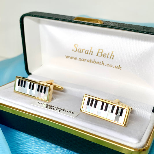 Piano cufflinks with white mother of pearl and black onyx keys gold plated.