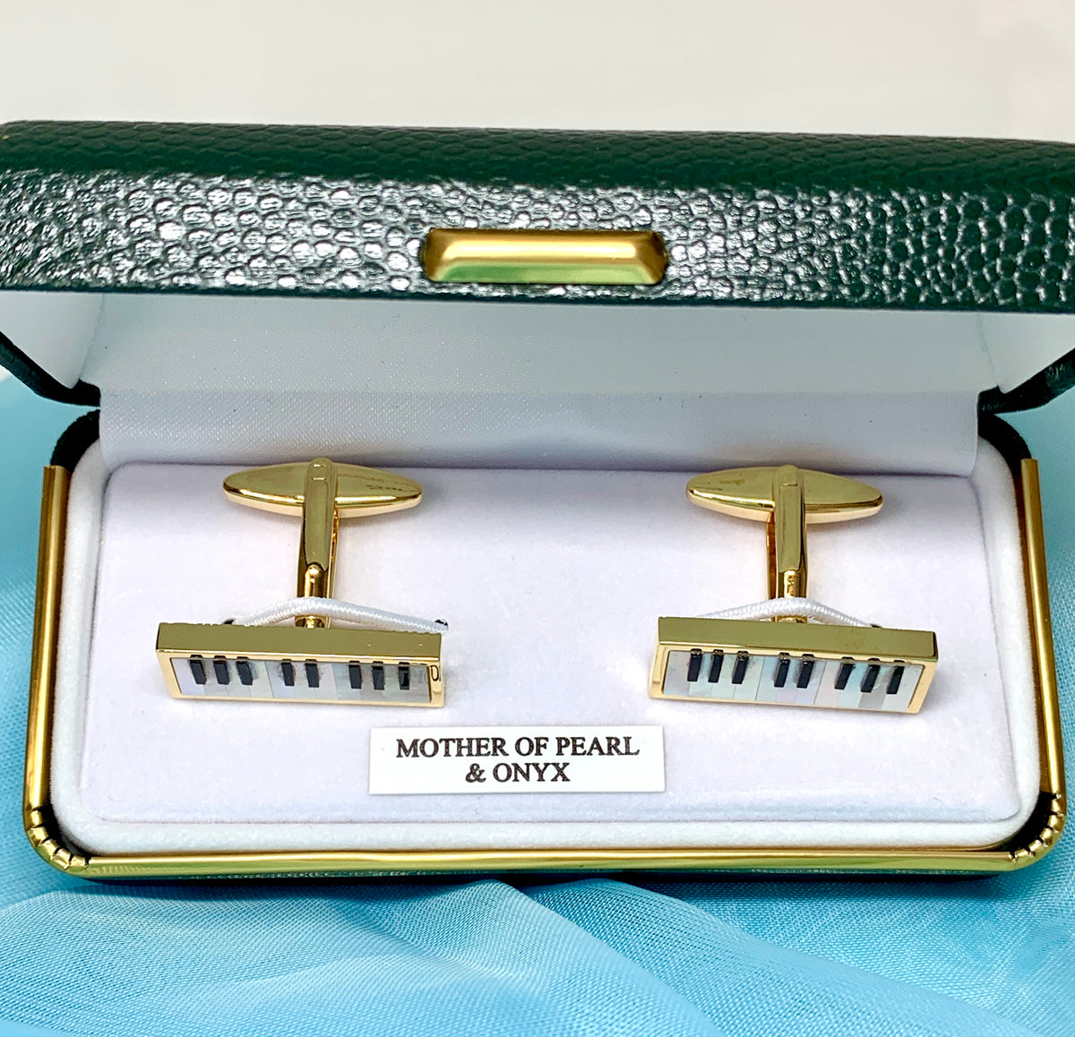 Piano cufflinks with white mother of pearl and black onyx keys gold plated.