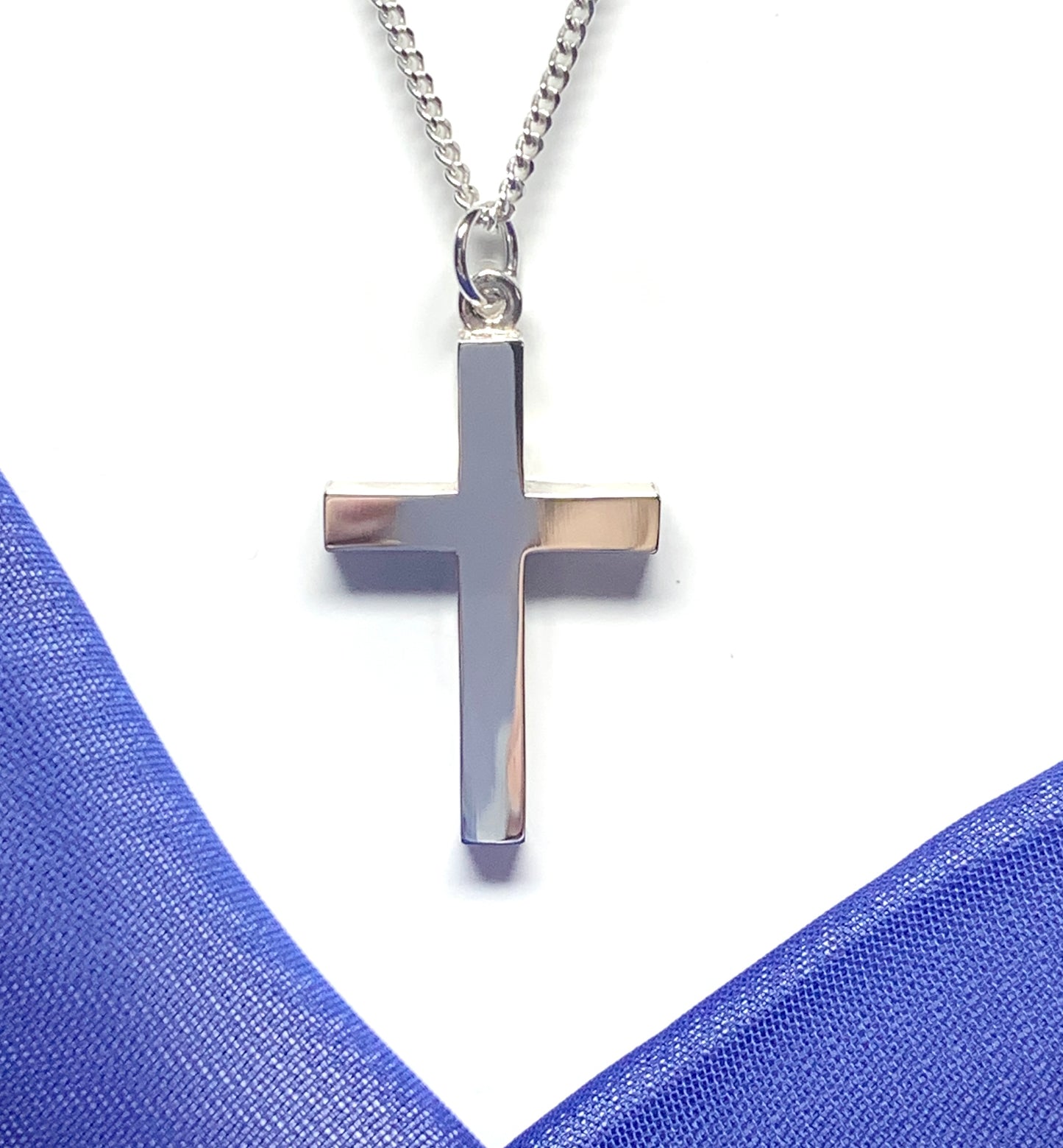 Polished plain heavy solid sterling silver cross on a curb chain