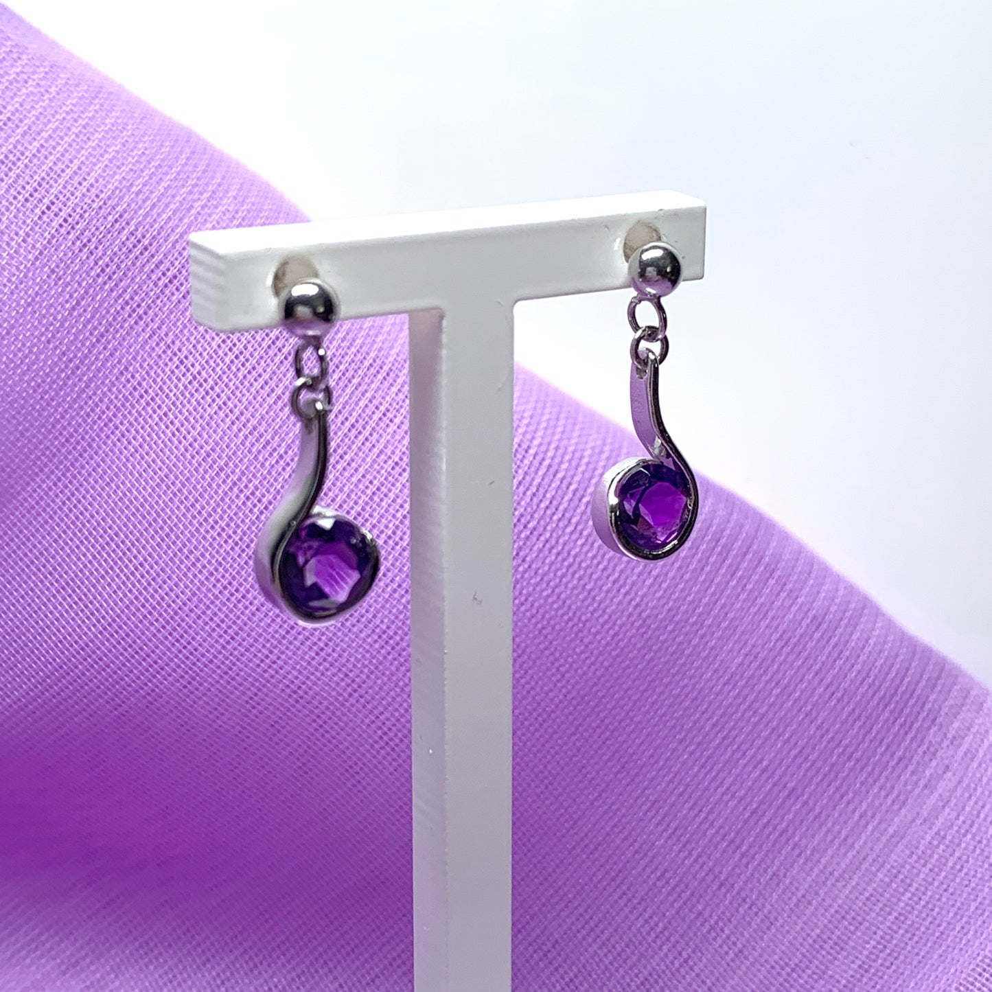 Purple amethyst white gold round drop swirl earrings