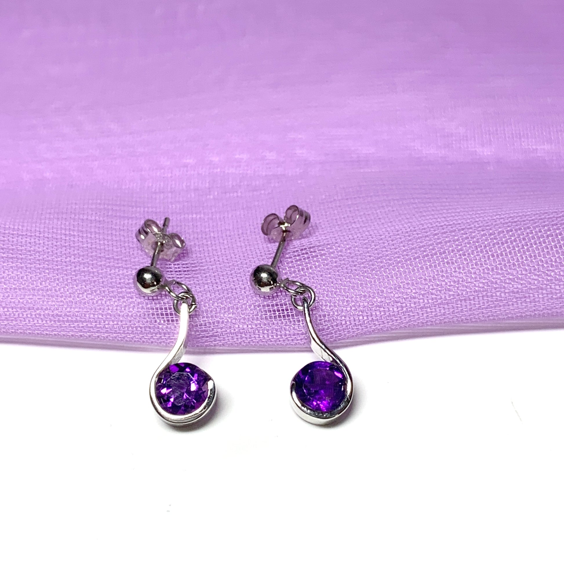 Purple amethyst white gold round drop swirl earrings