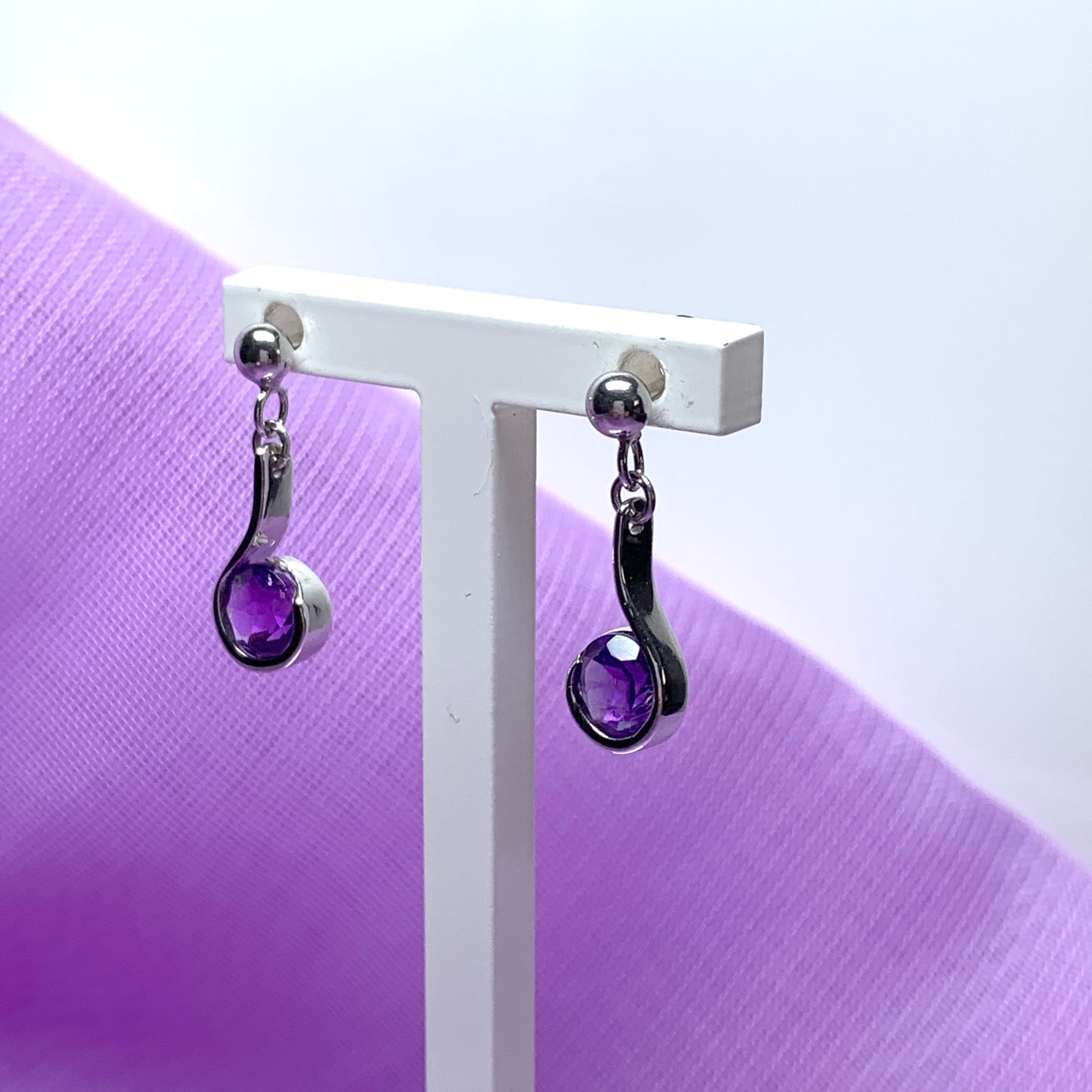 Purple amethyst white gold round drop swirl earrings