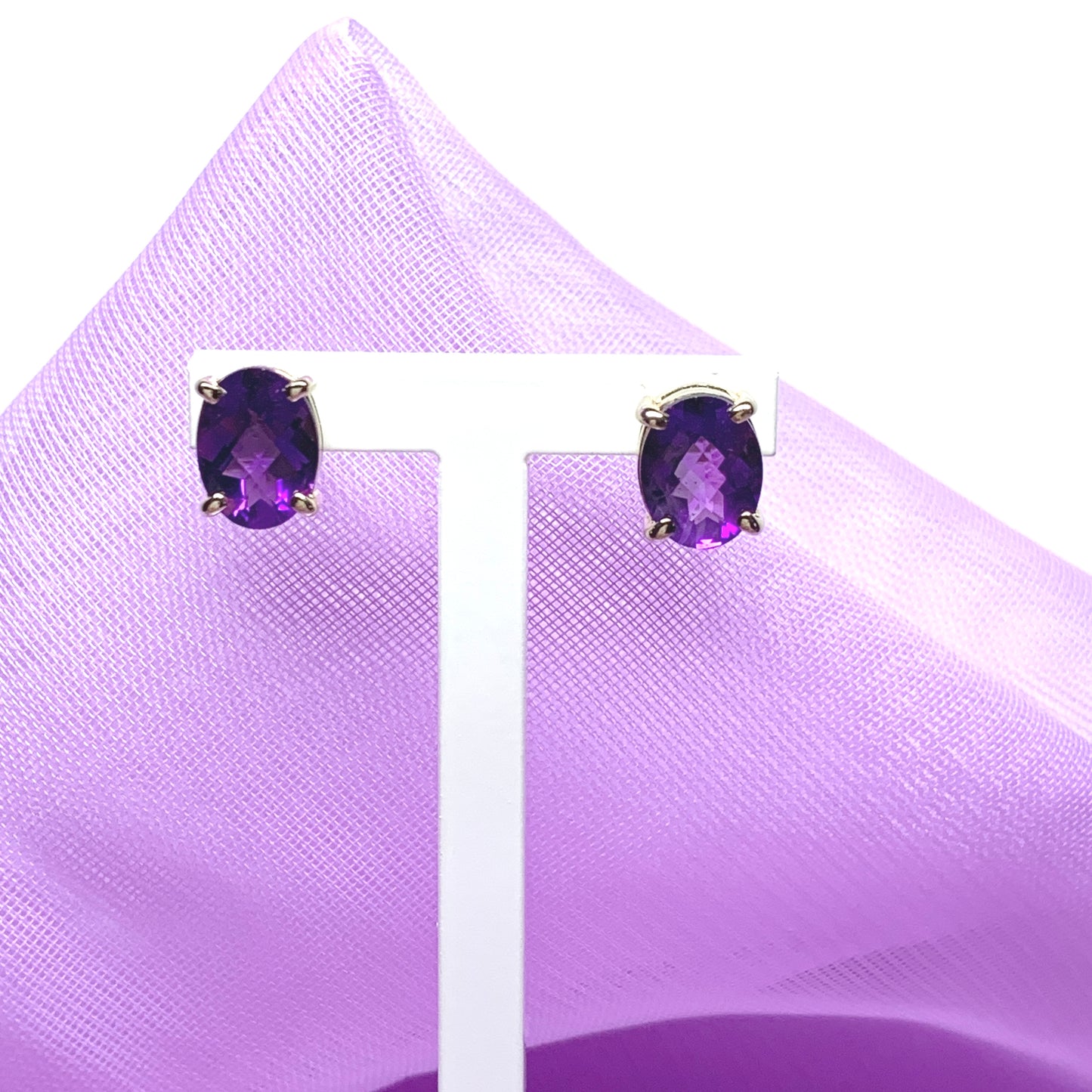 Purple oval amethyst stud earrings in yellow gold