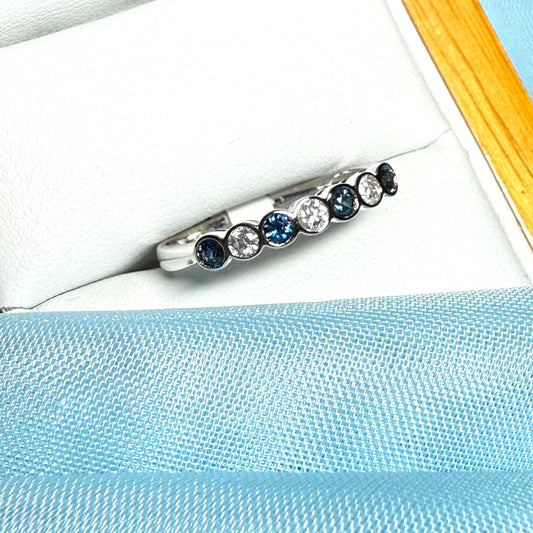 A real blue sapphire and diamond white gold eternity ring smooth setting