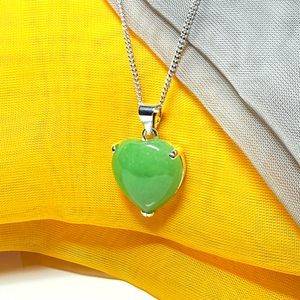 A real green jade necklace heart shaped sterling silver with chain included as well