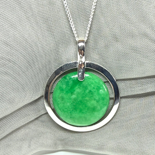 Real green jade necklace in a large round shape with a stunning designed halo pendant
