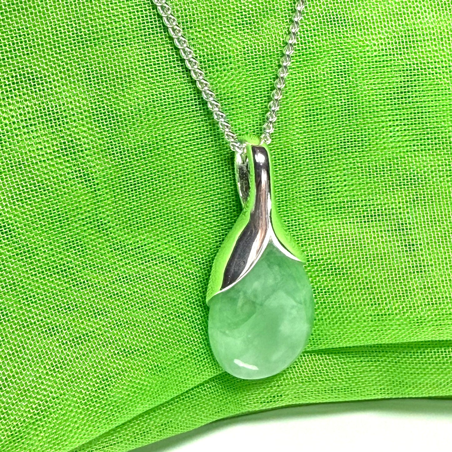 Real green jade necklace in a pear or tear drop shaped sterling silver pendant with chain
