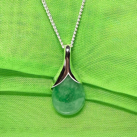 A real green jade necklace in a teardrop or pear shape, a traditional pendant