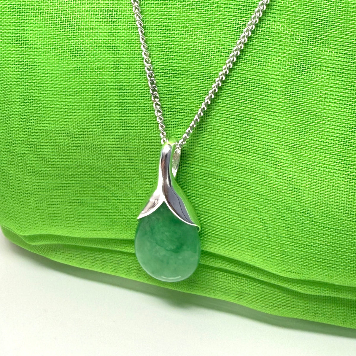 Real green jade necklace in a teardrop or pear shaped, a timeless designed pendant with a chain