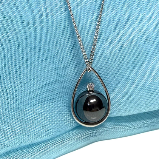 Real grey hematite necklace round inside a teardrop caged pendant