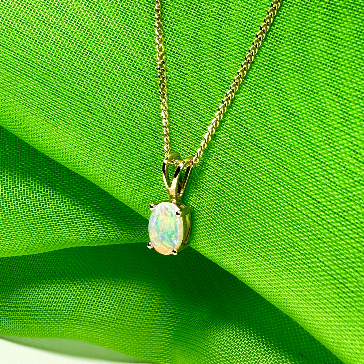 Real opal pendant oval cut yellow gold
