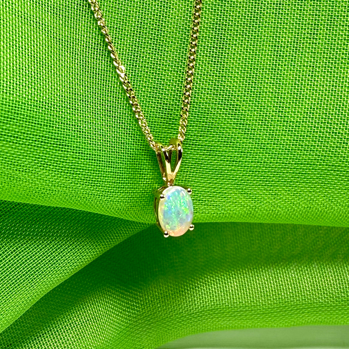 Real opal pendant oval cut yellow gold