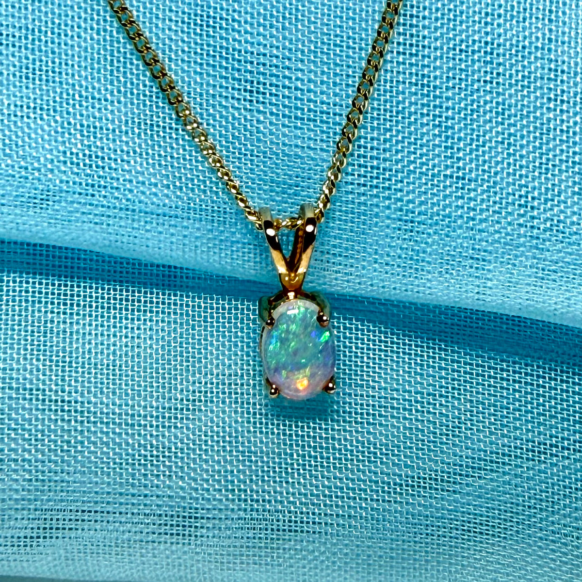 Real opal pendant oval yellow gold