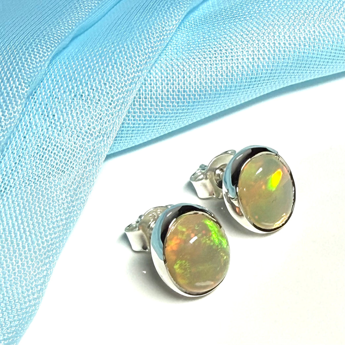 Real opal sterling silver oval shaped stud earrings