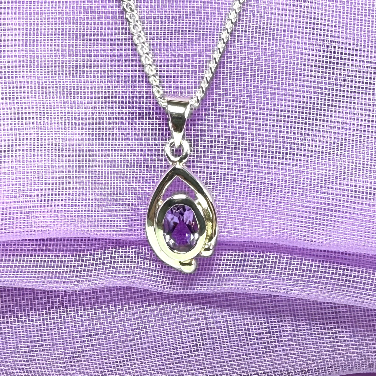 Real purple amethyst oval shaped sterling silver necklace with a smooth rubbed over pierced pendant with chain