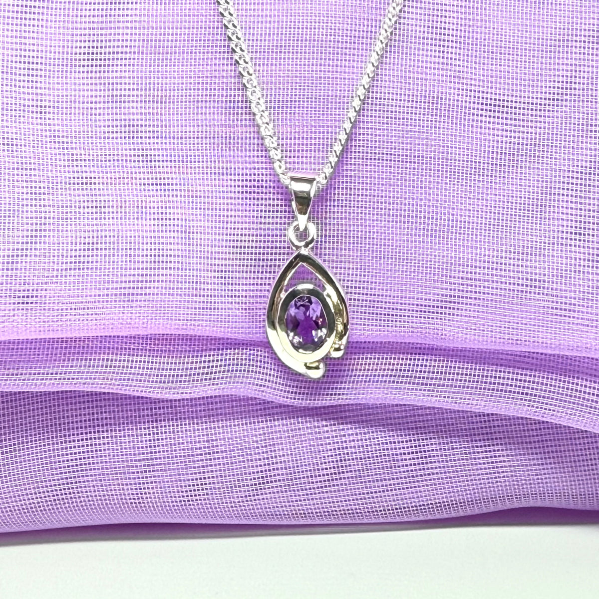Real purple amethyst oval shaped sterling silver necklace with a smooth rubbed over pierced pendant with chain