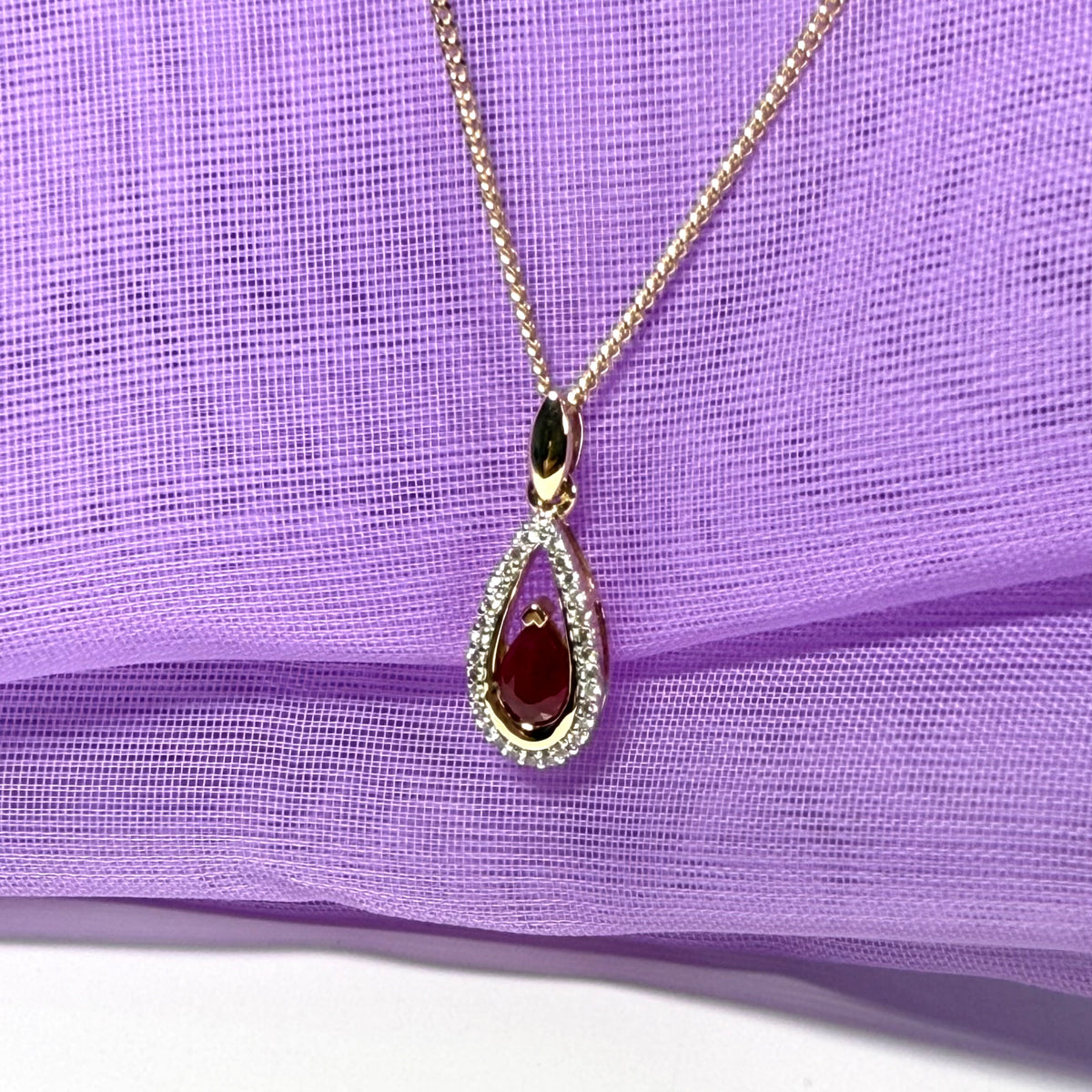 Real red pear shaped ruby and diamond pierced necklace yellow gold