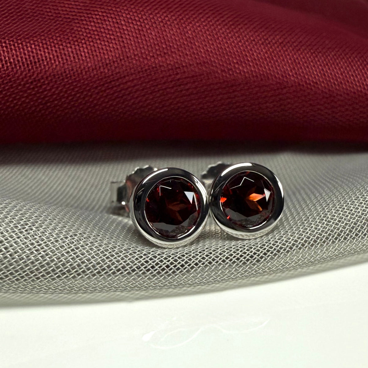 Real red round garnet stud earrings smooth rubbed over edges