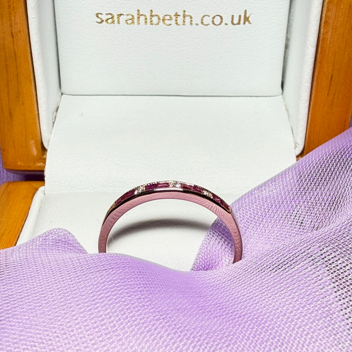Real red ruby and diamond channel set eternity ring yellow gold
