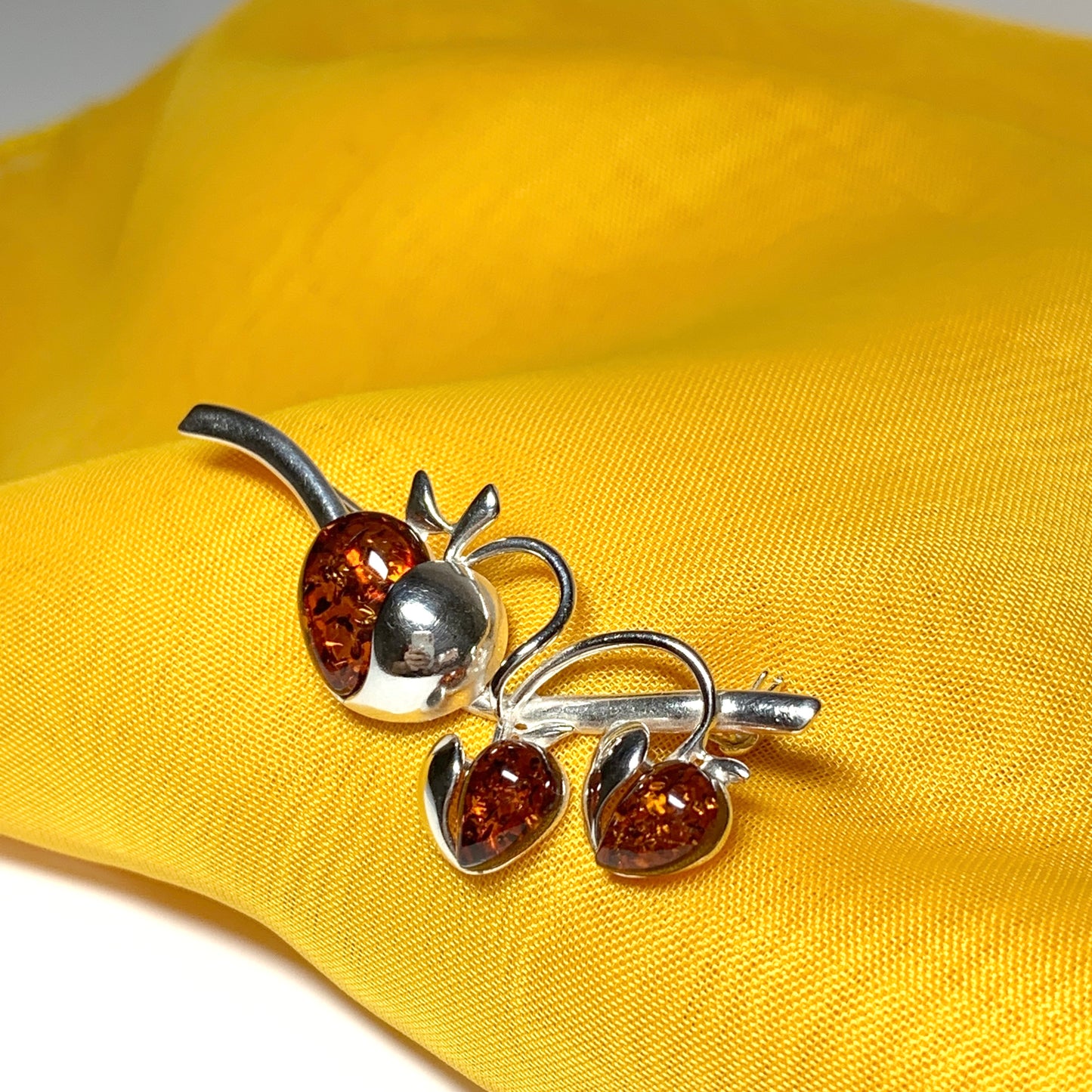 Real amber triple heart shaped and sterling silver brooch