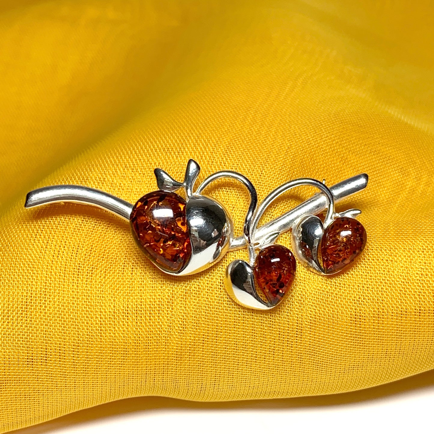 Real amber triple heart shaped and sterling silver brooch