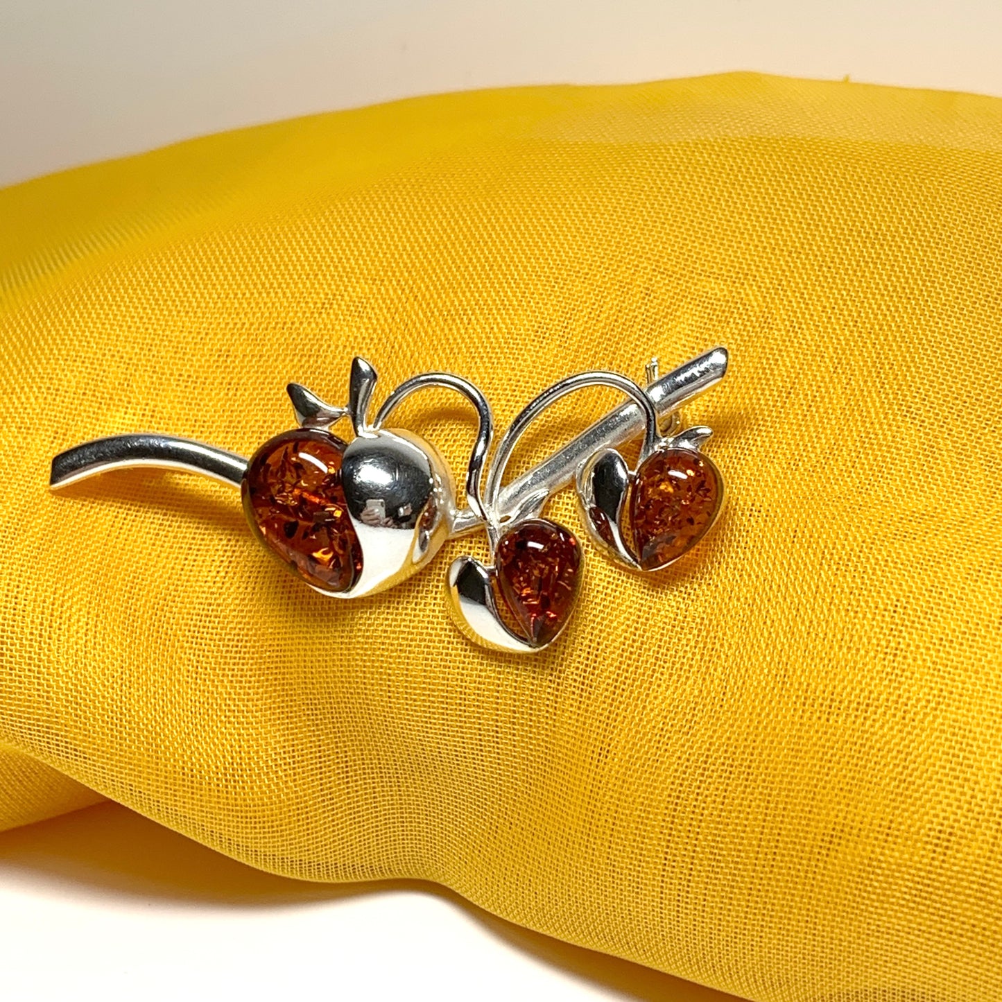 Real amber triple heart shaped and sterling silver brooch