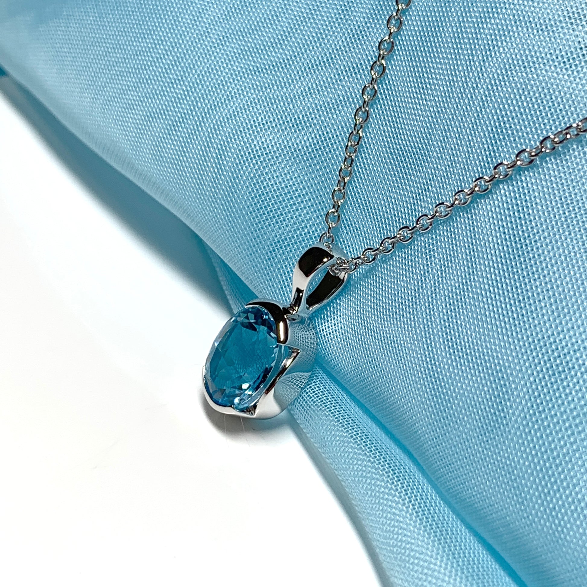 Real blue topaz necklace pendant oval smooth rubbed over setting