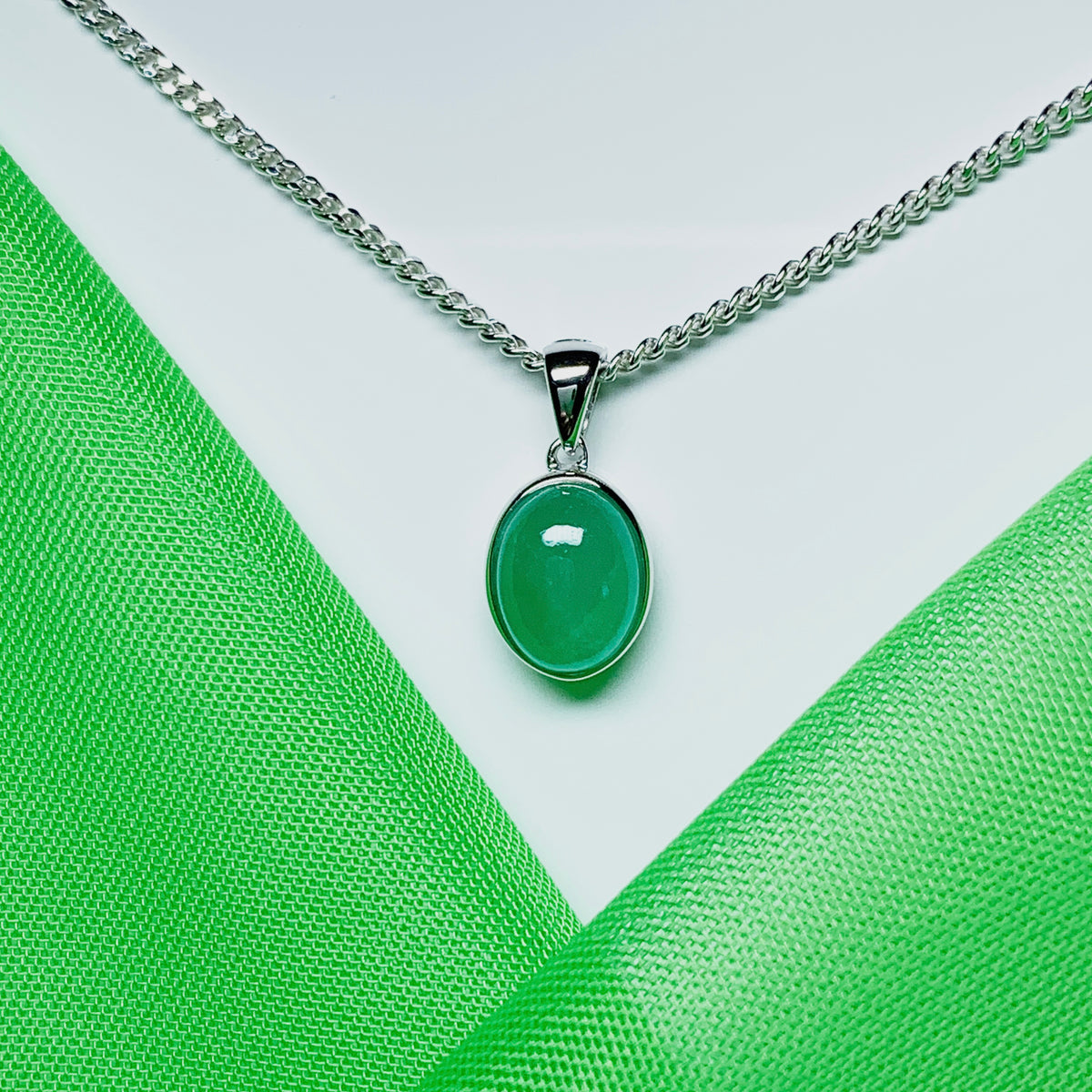 Real green jade necklace white gold oval rubbed over smooth setting