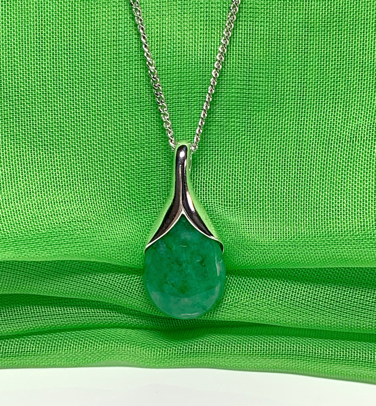 Real green jade necklace in a pear or tear drop shaped sterling silver pendant