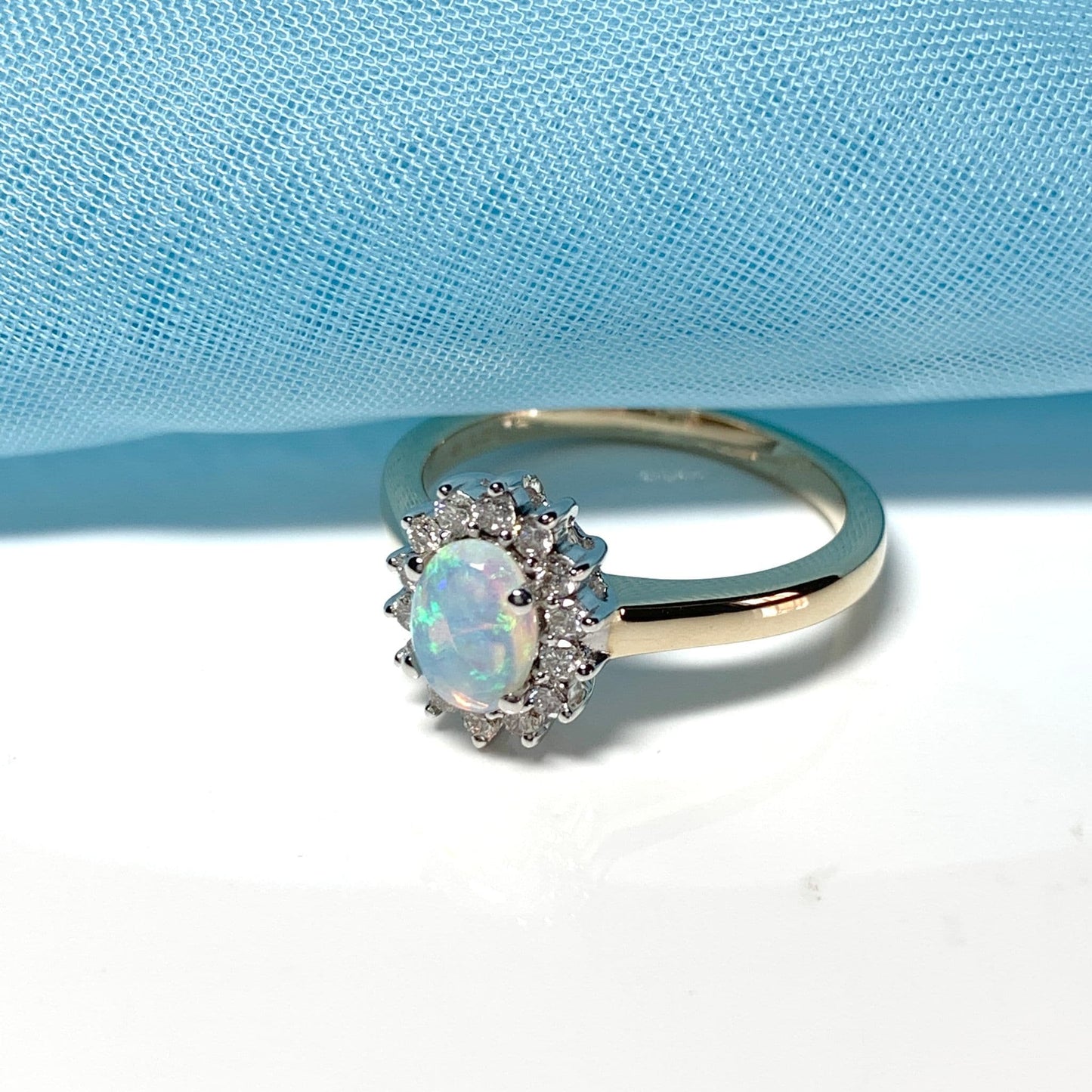 Real oval opal and diamond cluster yellow gold ring
