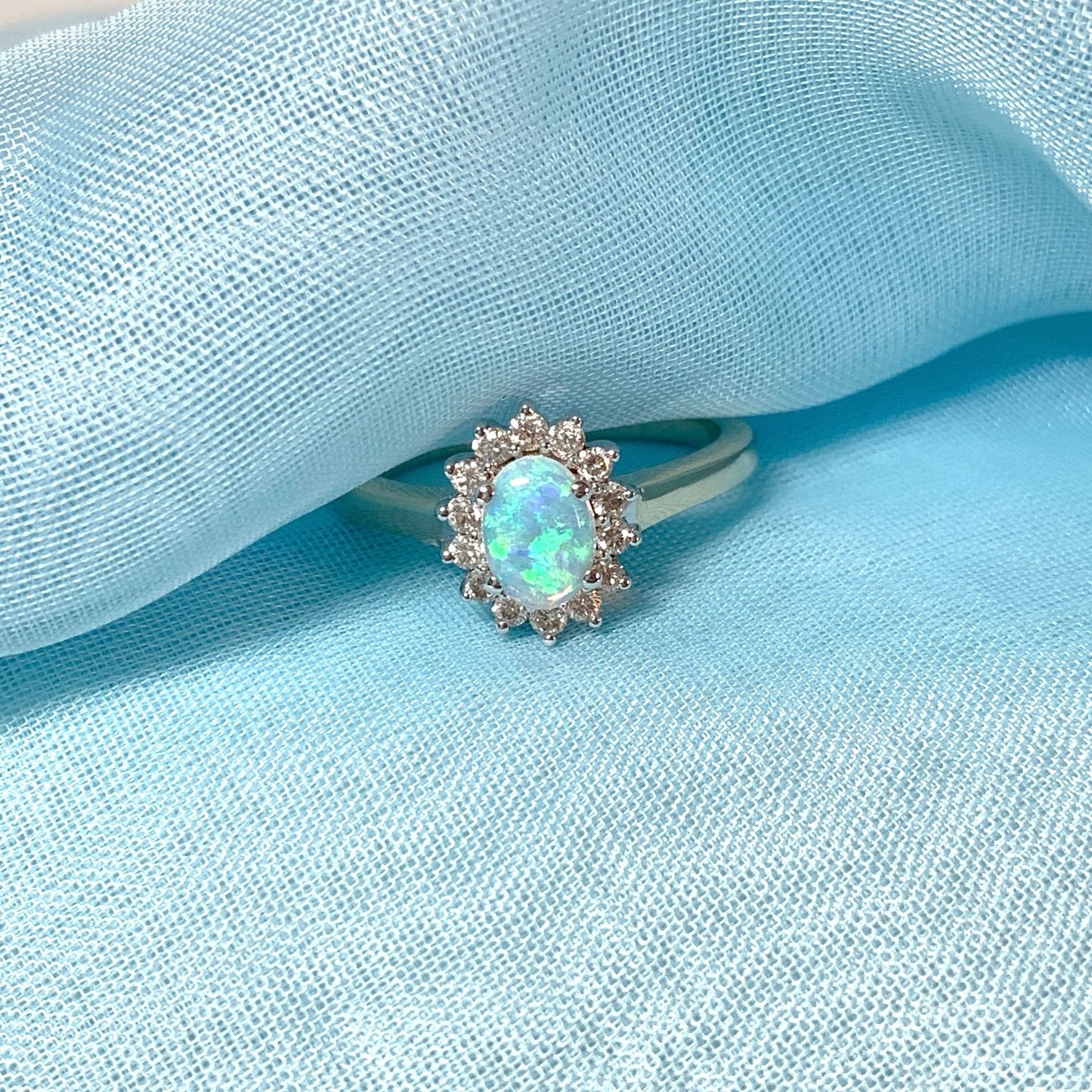 Real oval opal and diamond cluster yellow gold ring