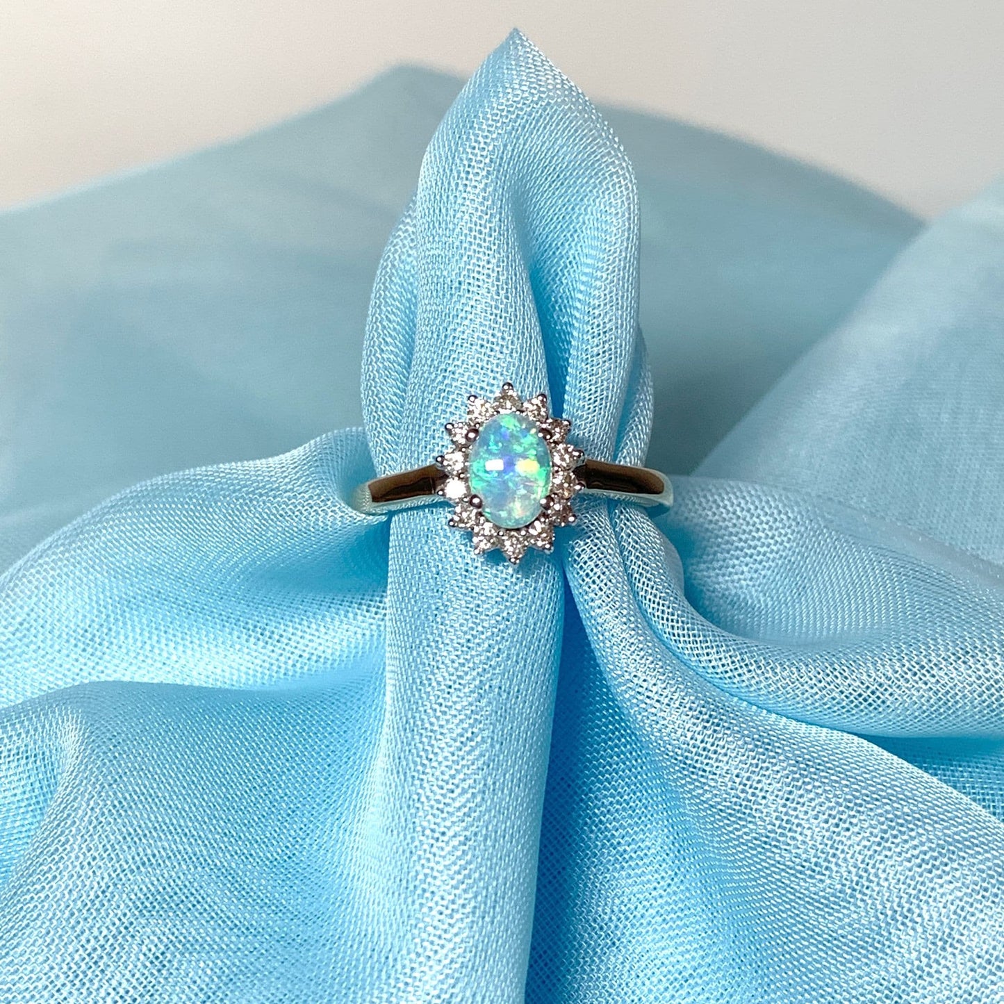 Real oval opal and diamond cluster yellow gold ring
