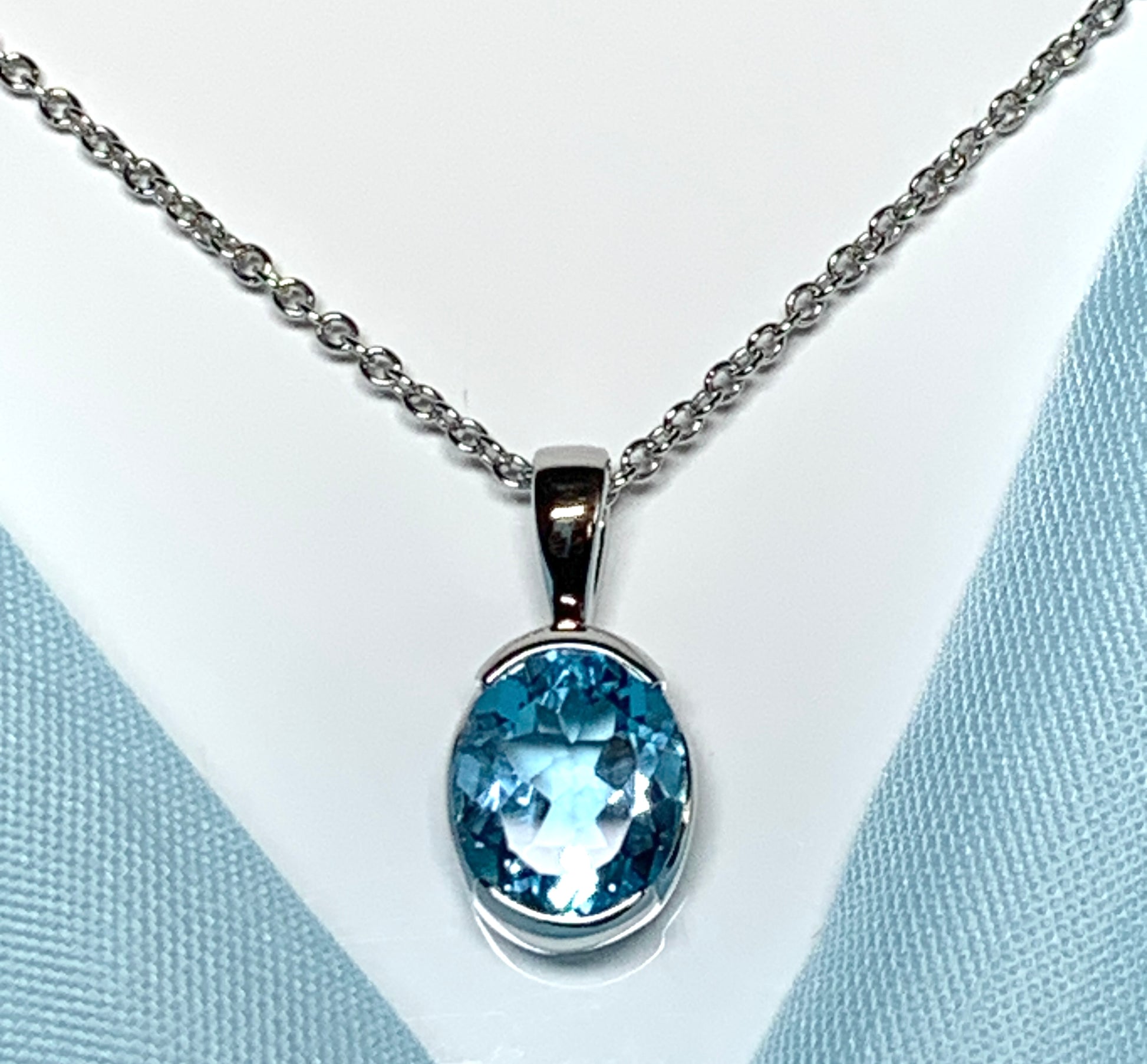 Real blue topaz necklace pendant oval smooth rubbed over setting