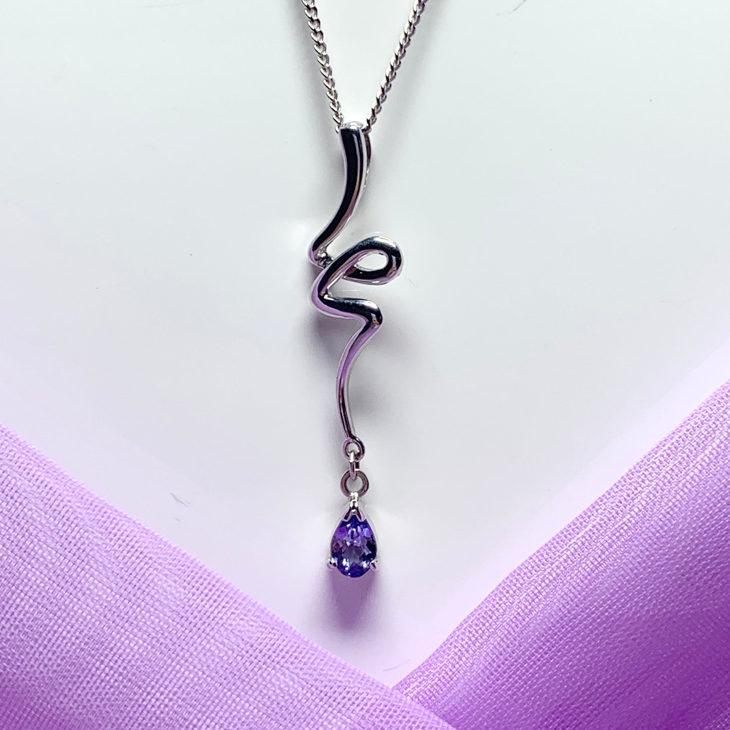 Real tanzanite white gold fancy swirl necklace pear shaped