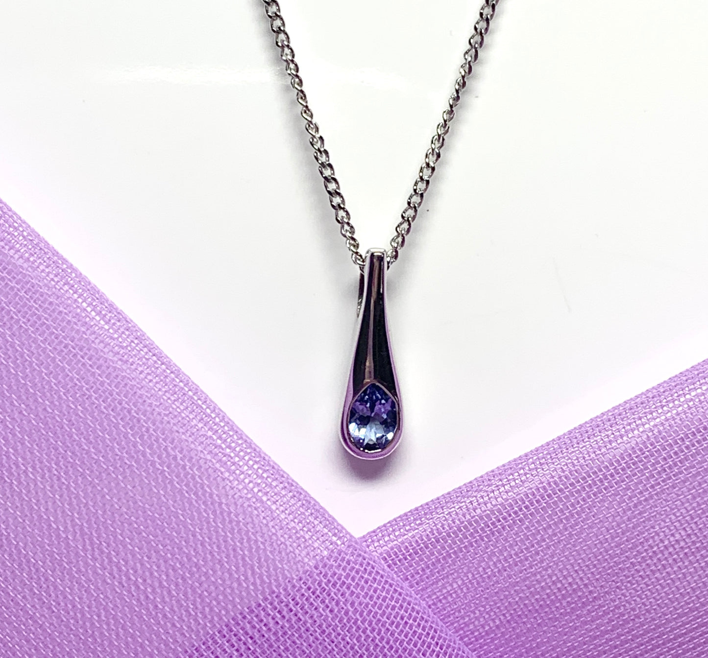 Real tanzanite white gold necklace rubbed over setting