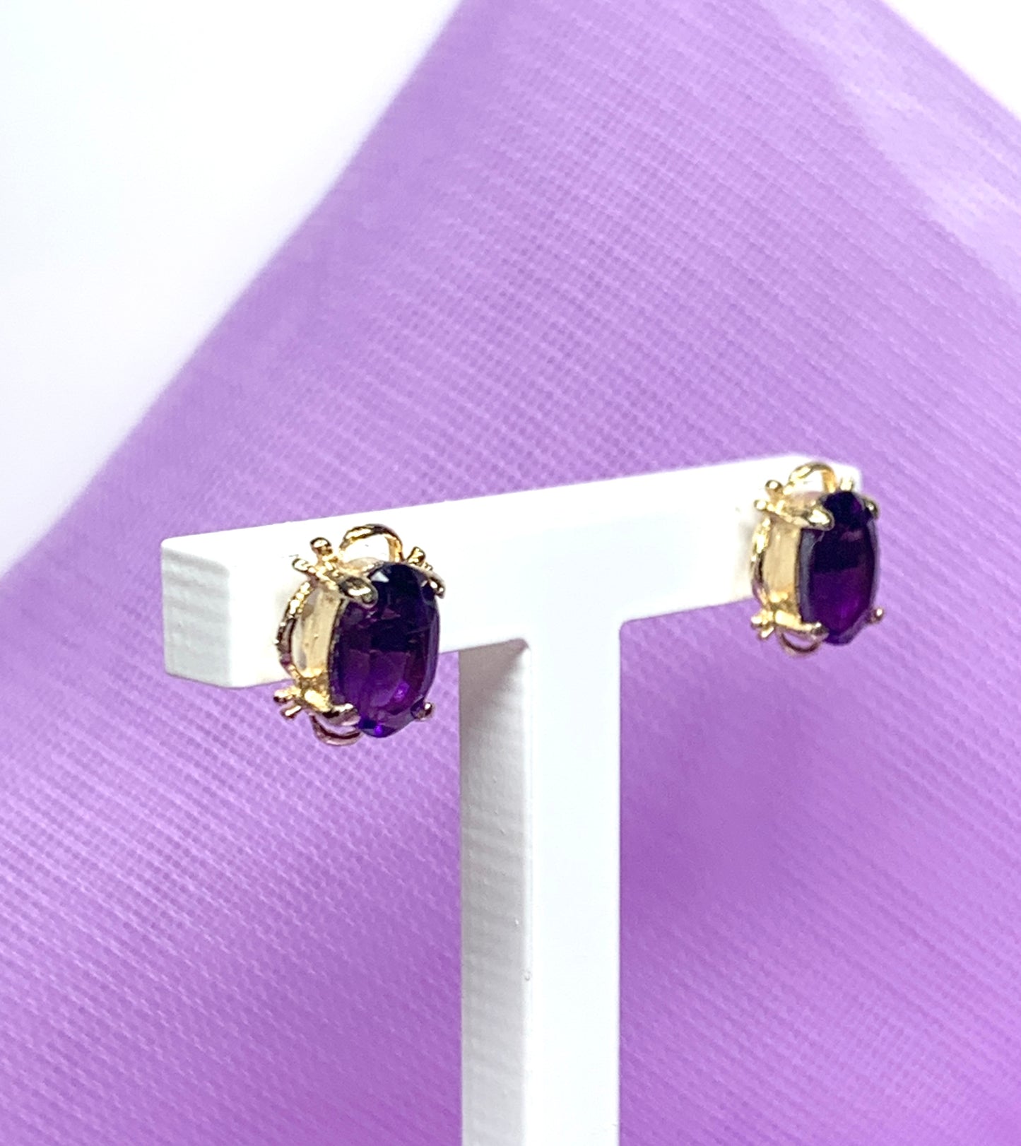 Yellow gold oval purple amethyst stud earrings with fancy edging